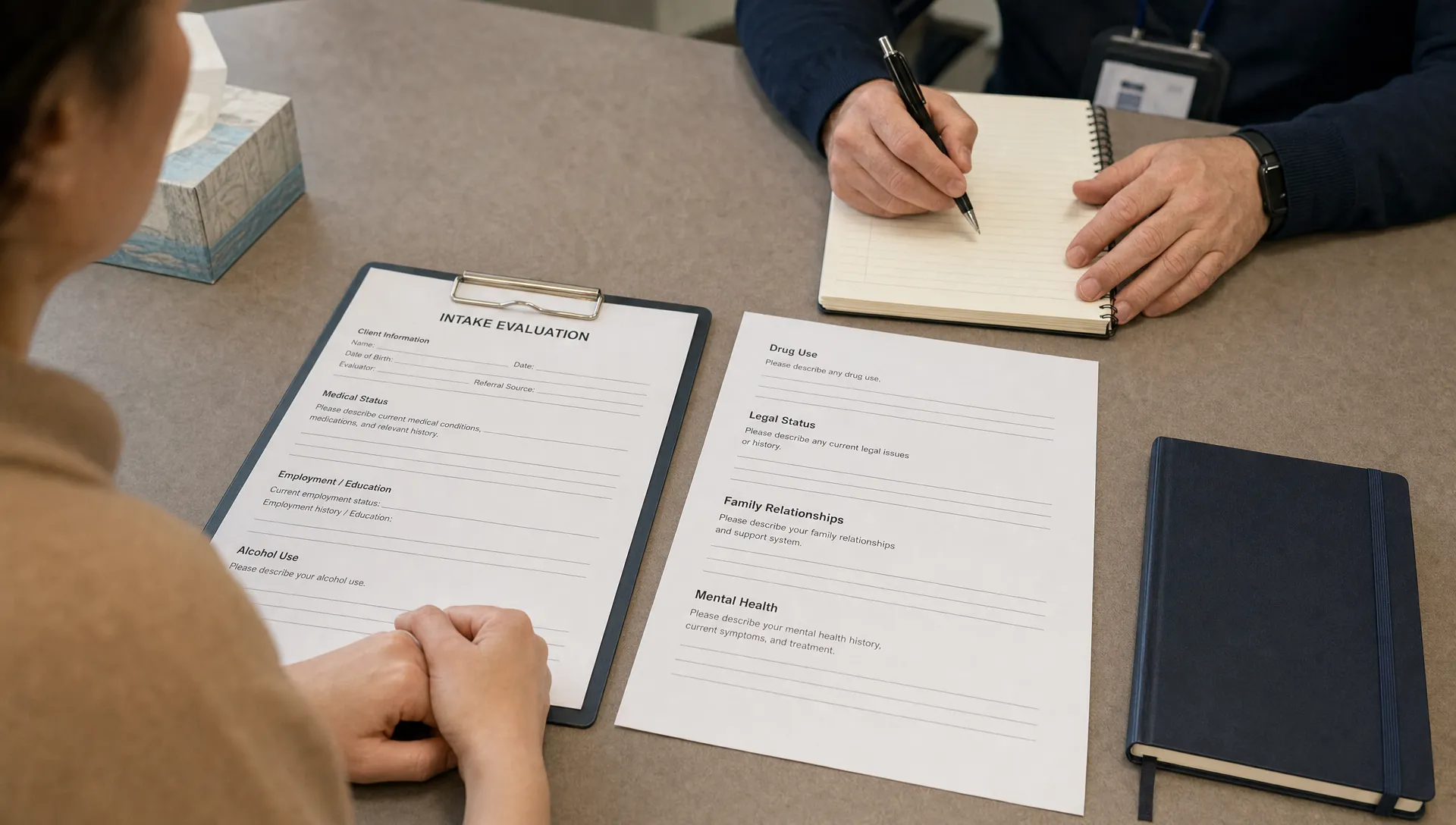 A consultation table holds evaluation forms, a notebook, and sections for medical status, employment, alcohol use, drug use, legal status, family relationships, and mental health.